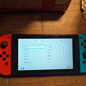 Nintendo Handheld Console with Red and Blue Controllers